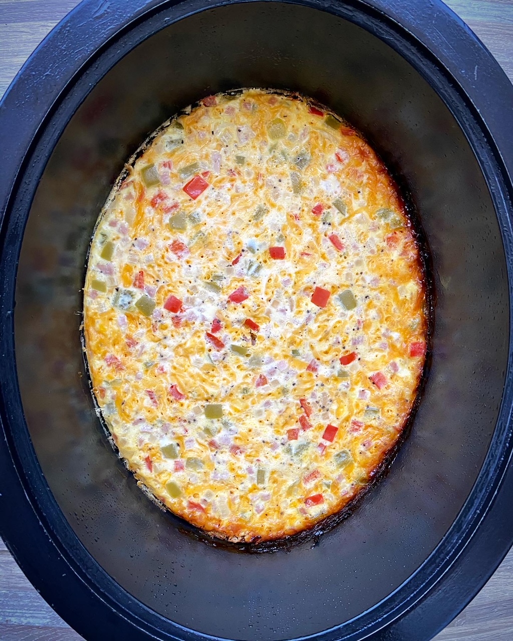 overhead shot of cooked Slow Cooker Denver 'Omelette' Casserole  in a black slow cooker