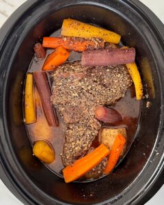 overhead shot of cooked 5-Ingredient Pot Roast in a black slow cooker