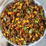 overhead shot of cooked crockpot Tex-Mex ground meat in a white bowl