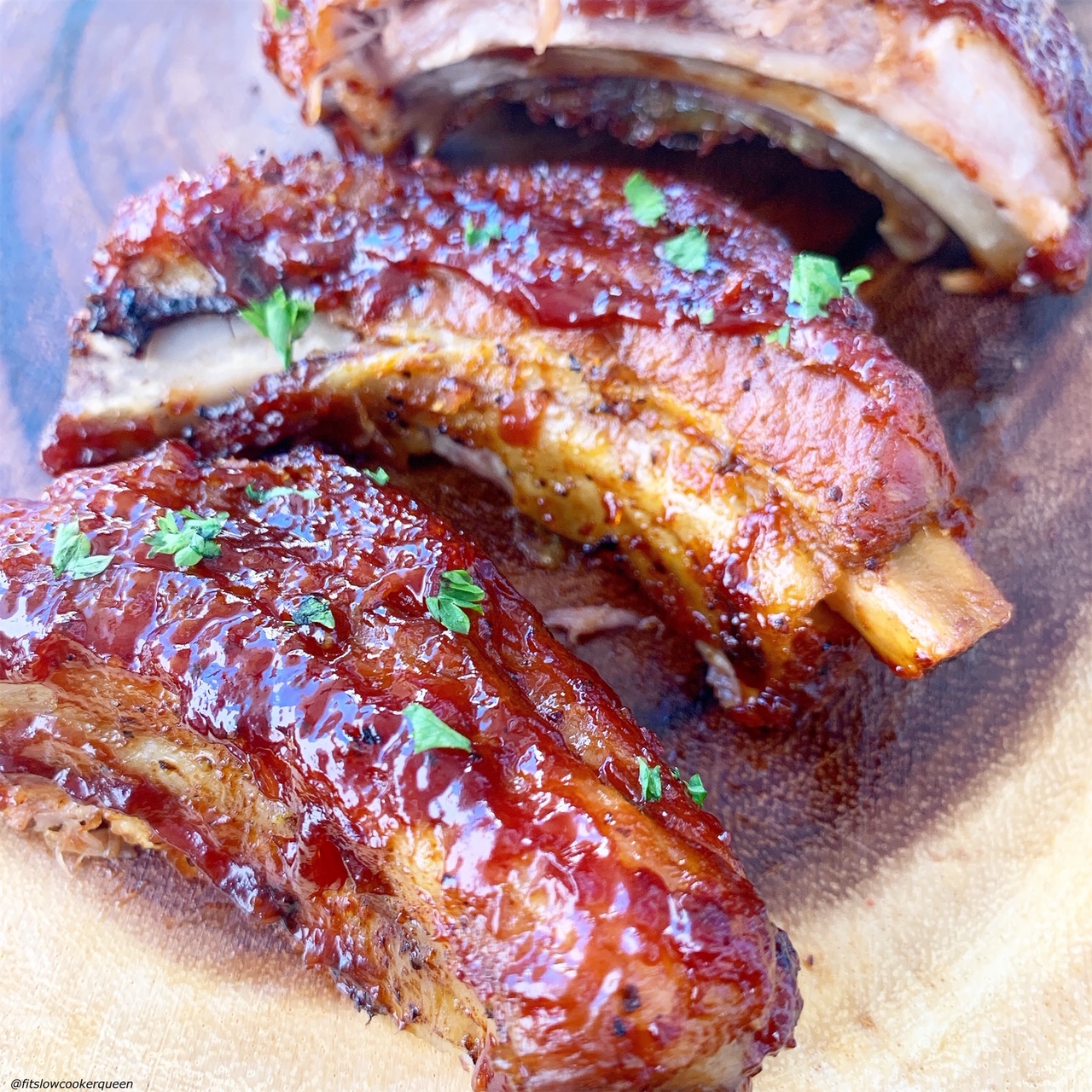 close up shot of BBQ pork ribs on a wooden cutting board