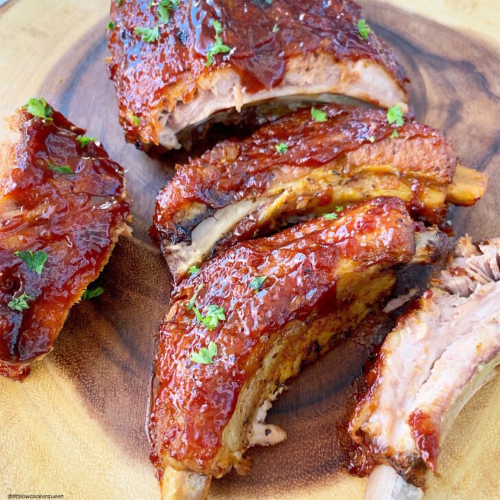 close up shot of BBQ pork ribs on a wooden cutting board