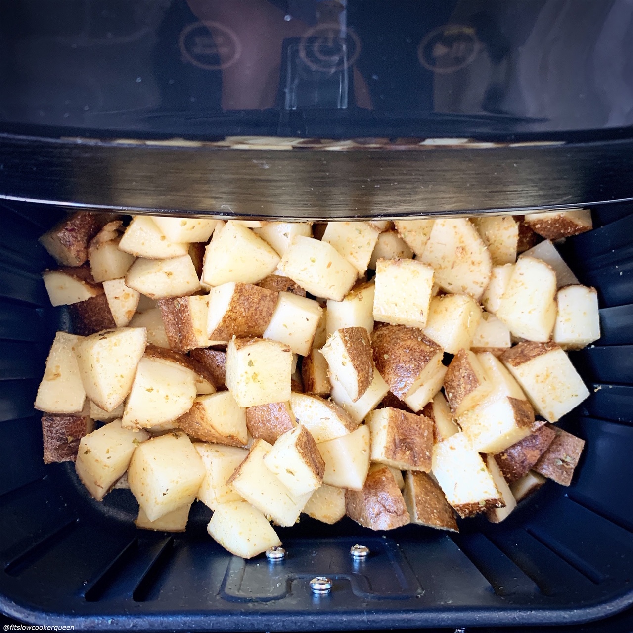raw diced potatoes in the air fryer before cooking