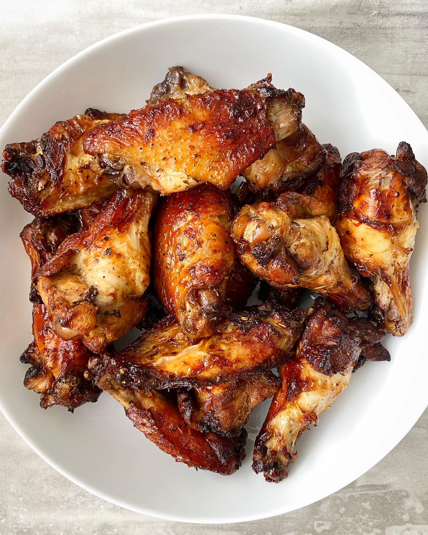 cooked marinated air fryer chicken in a white bowl