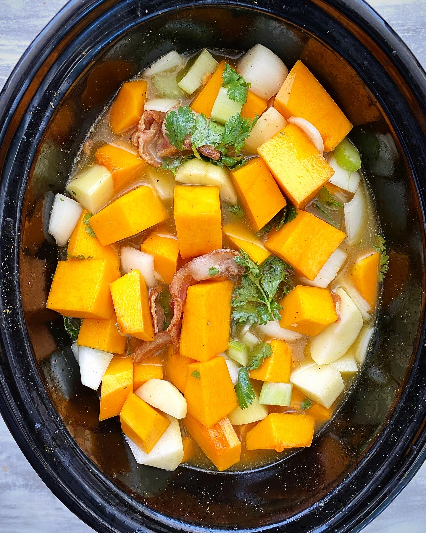 overhead shot of uncooked butternut squash soup in the slow cooker 