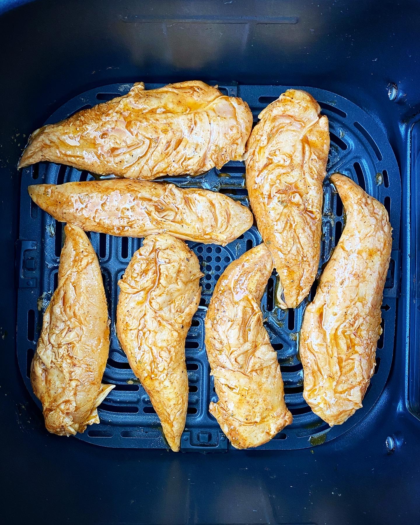 uncooked spicy naked chicken tenders in the air fryer