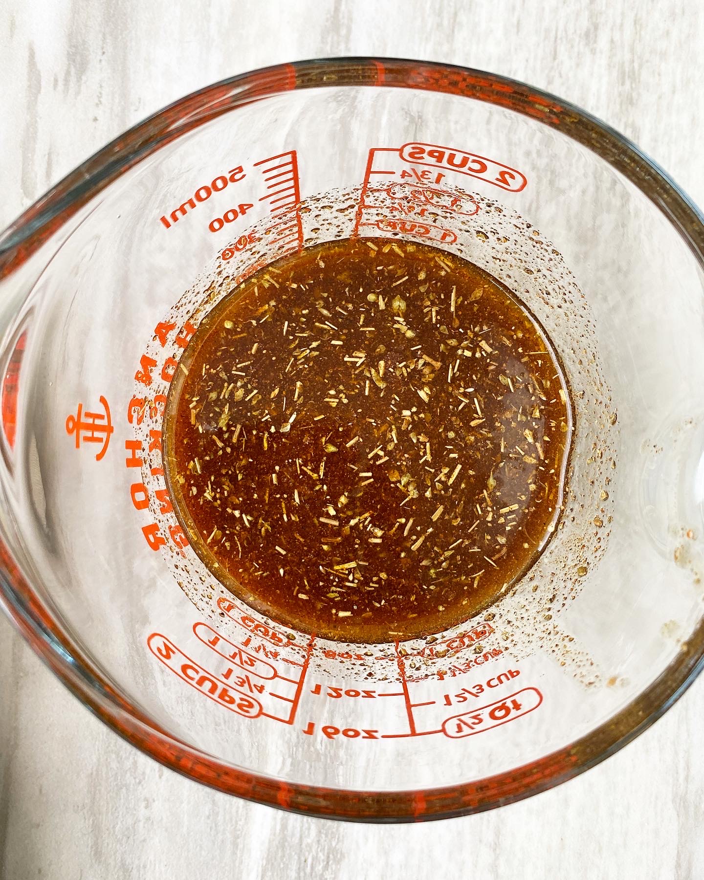 spicy marinade in a clear measuring cup 