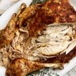 overhead shot of cooked whole turkey with the right breast sliced