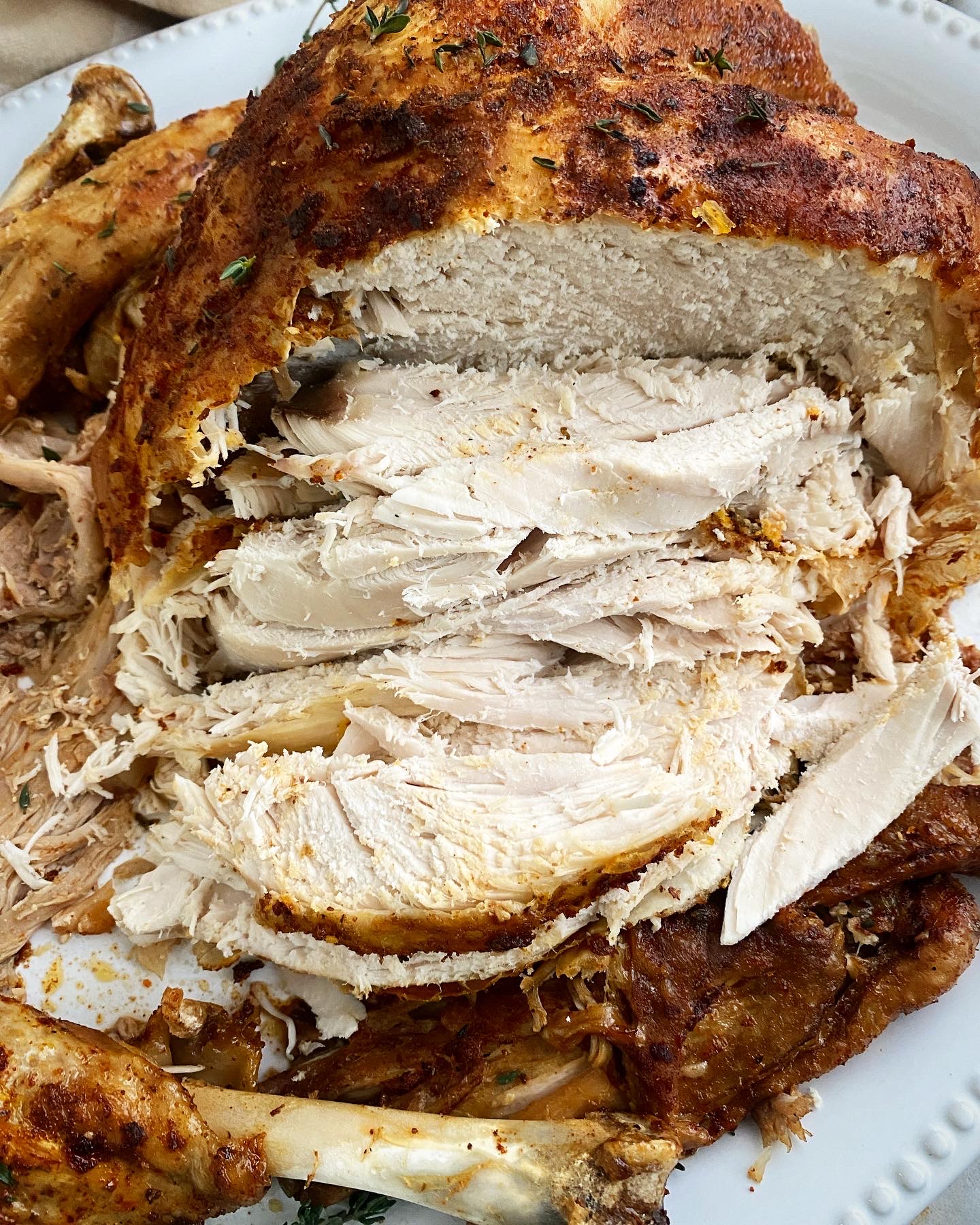 close up shot of cooked, sliced whole turkey