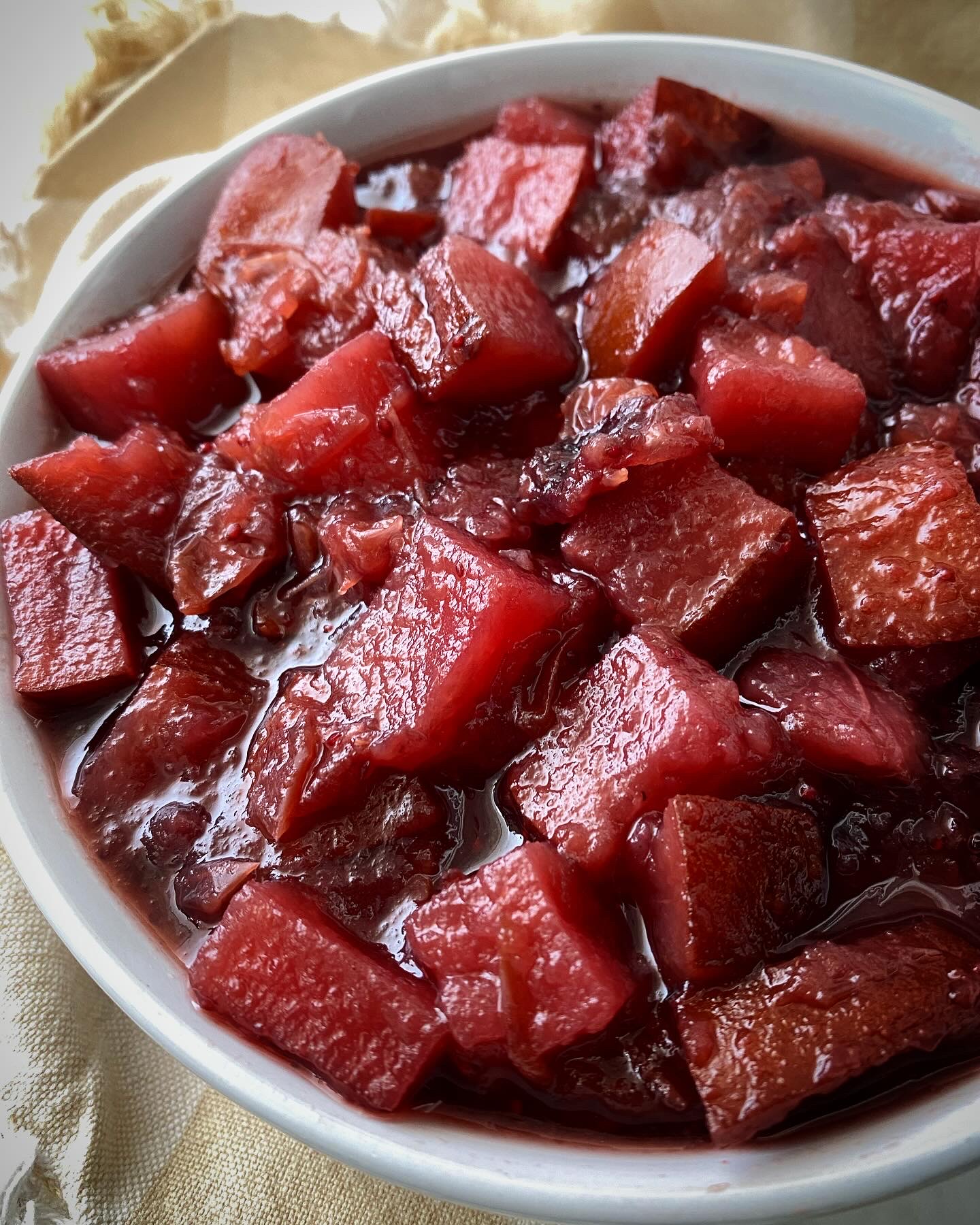 close up shot of homemade cranberry sauce in a white bowl