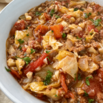 overhead shot of slow cooker unstuffed cabbage rolls in a white bowl