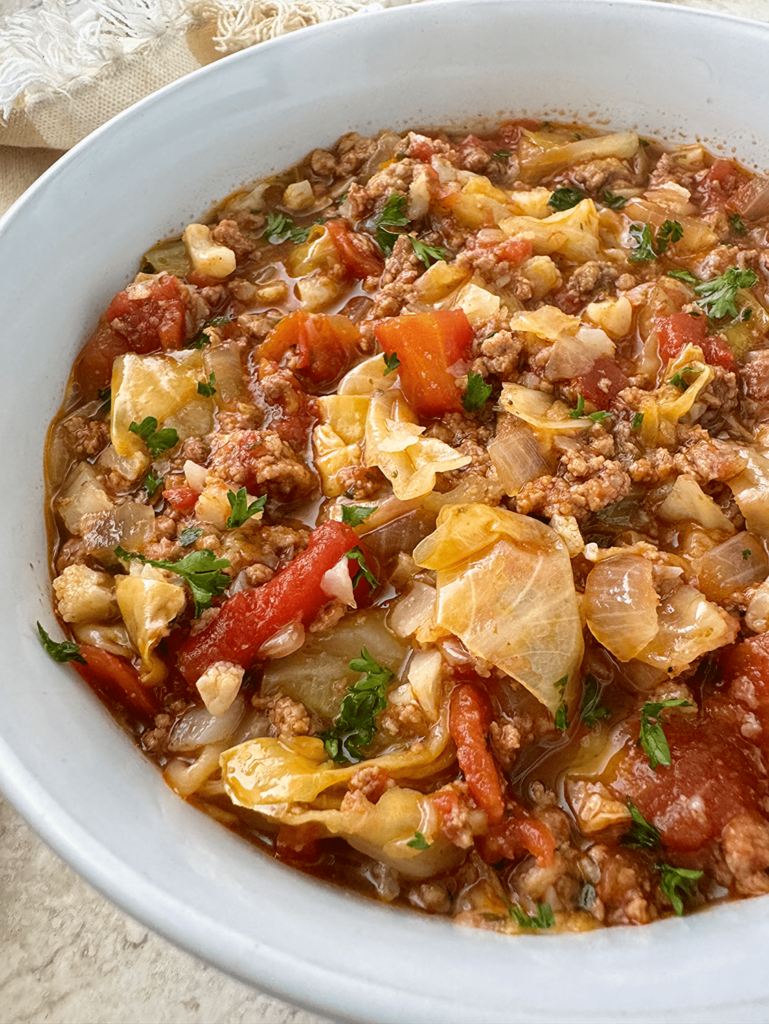 overhead shot of slow cooker unstuffed cabbage rolls in a white bowl