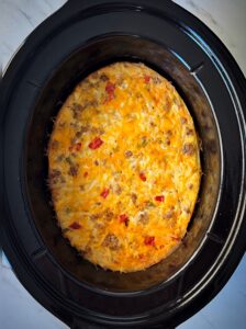 overhead shot of cooked breakfast casserole in a black slow cooker
