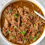 overhead shot of salsa verde beef in a white bowl