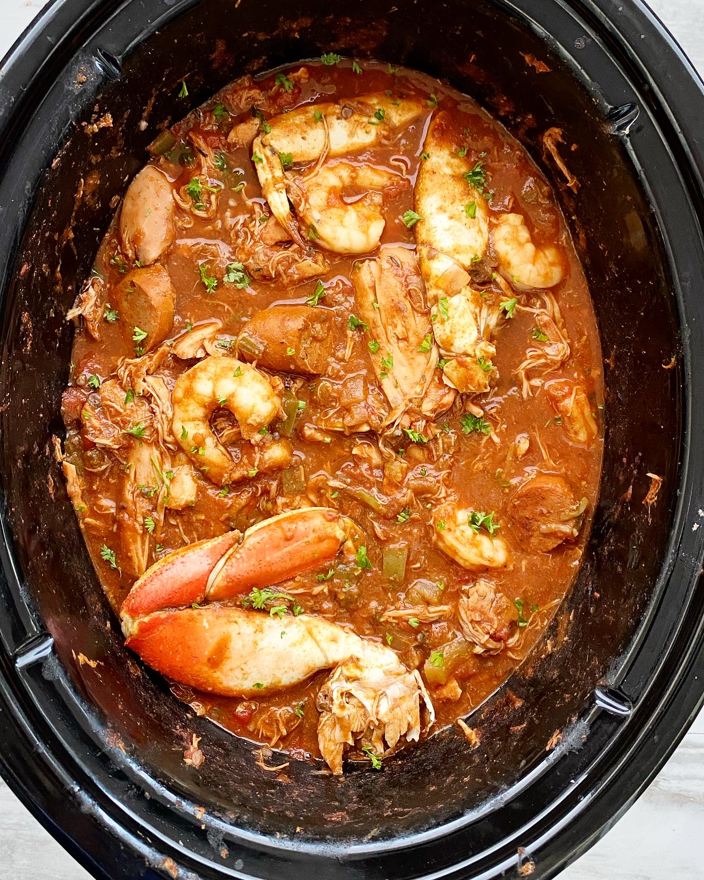 cooked gumbo in crockpot with seafood added