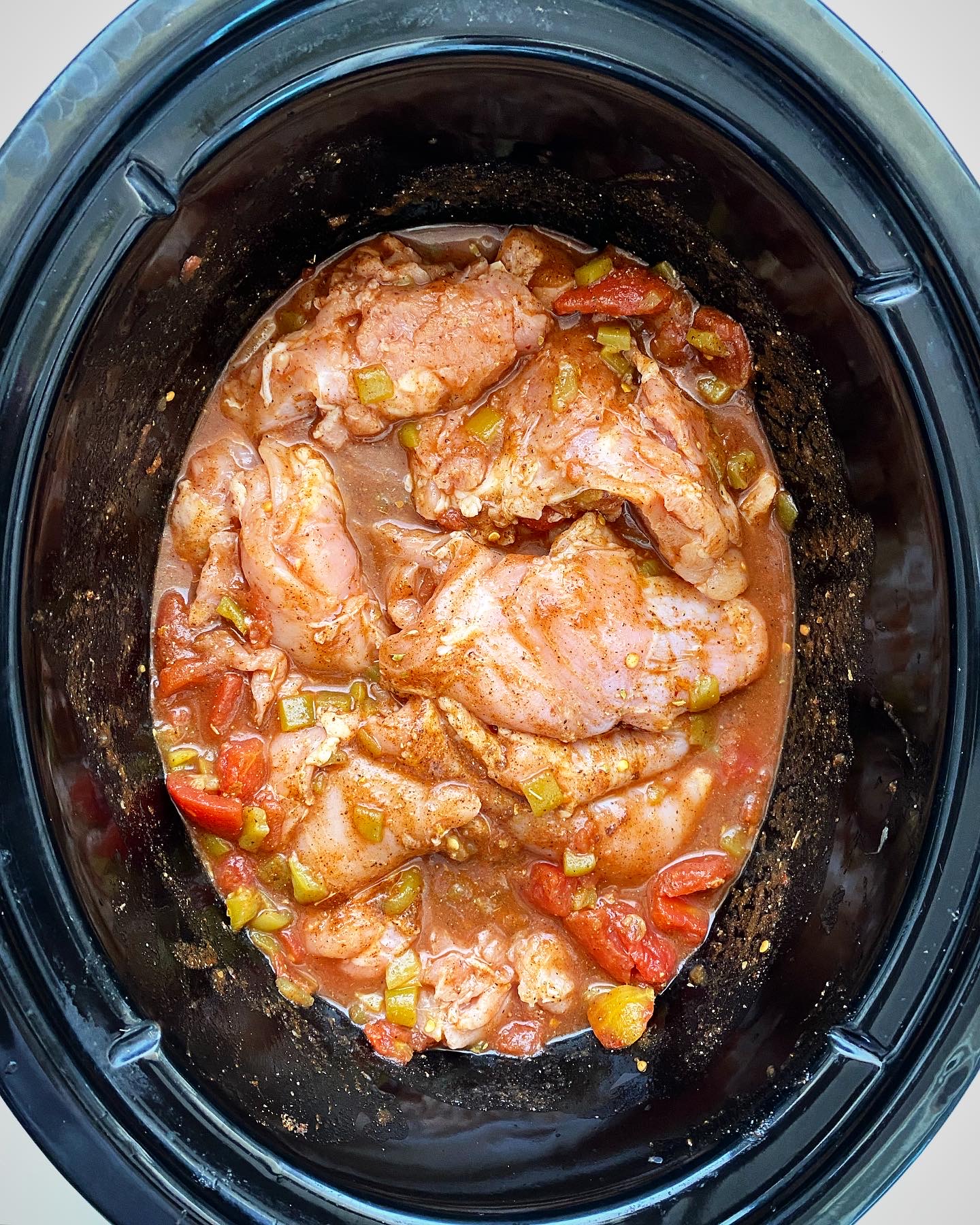 overhead shot of easy crockpot chicken tacos in a black slow cooker