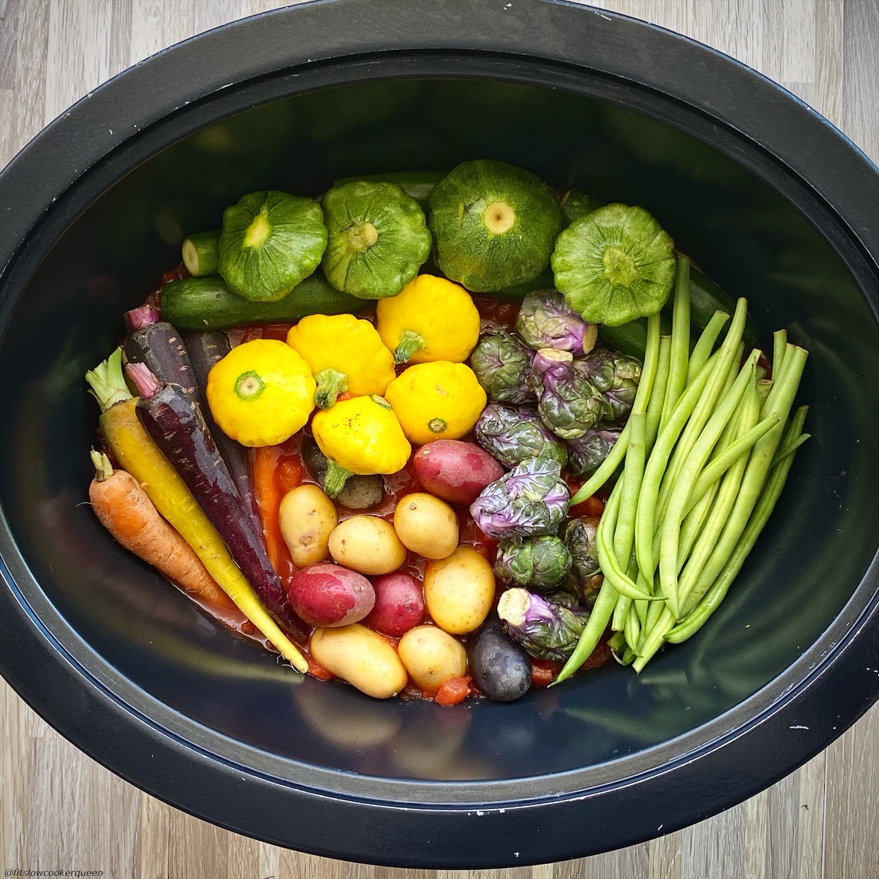assortment of raw vegetables in the slow cooker