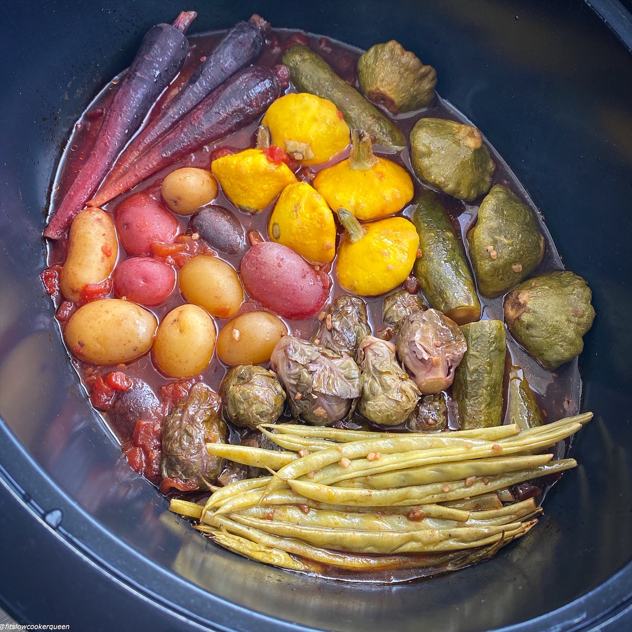 cooked vegetables in the slow cooker with sauce poured on top