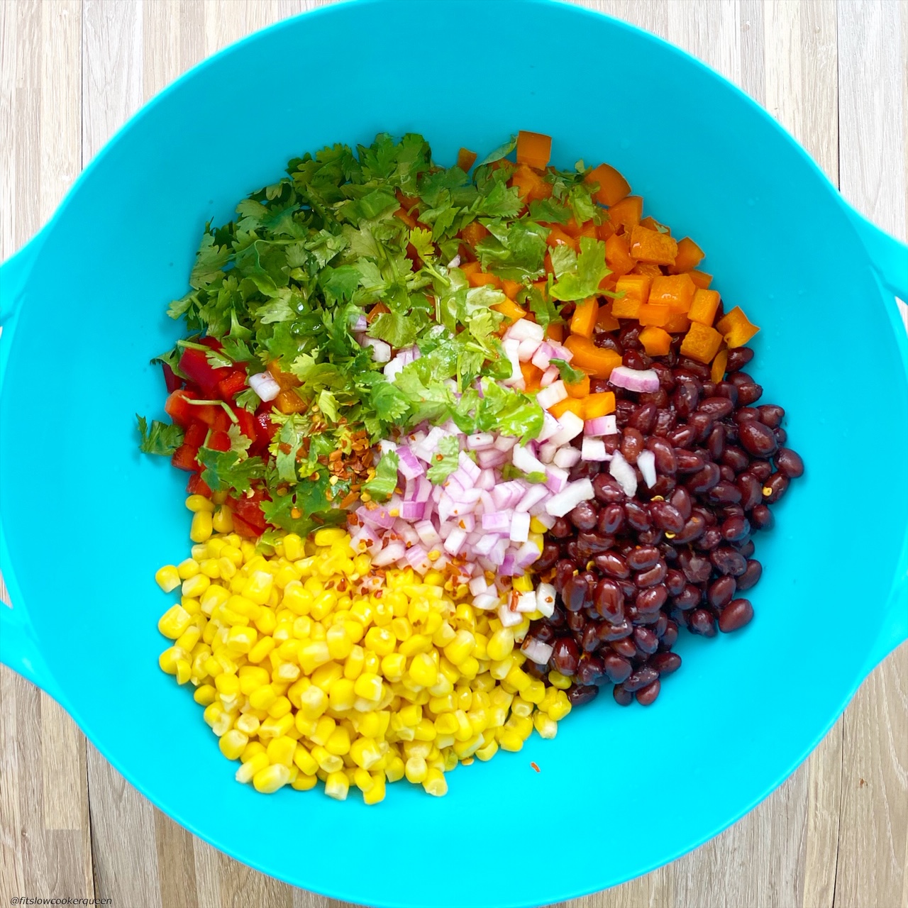 In a large bowl but not mixed together: black beans, corn, diced orange bell pepper, diced red bell pepper, red onion, fresh cilantro