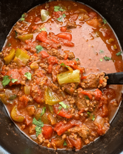 overhead shot of cooked Beef Chili Stew in a black slow cooker