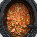 overhead shot of cooked Beef Chili Stew in a black slow cooker
