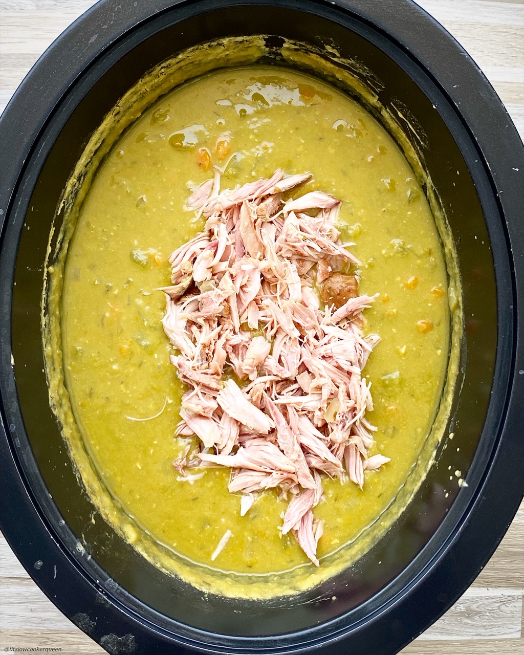cooked split pea soup in the slow cooker with shredded smoked turkey on top {VIDEO} Slow CookerInstant Pot Split Pea Soup (Whole30)