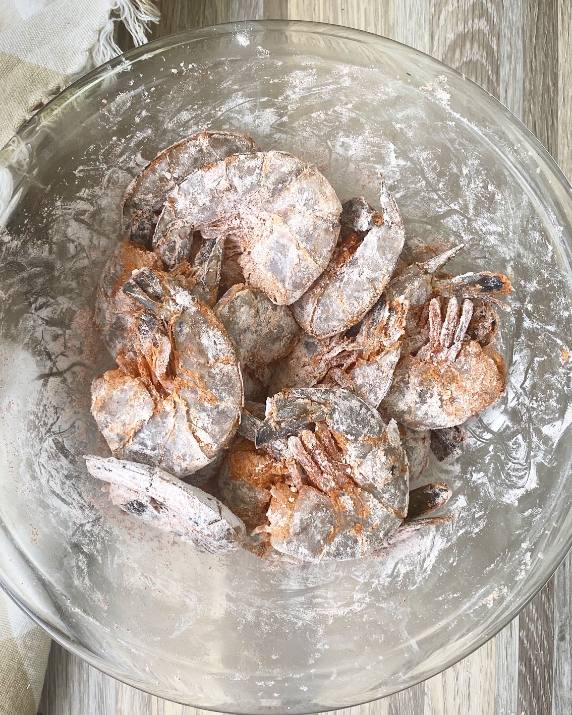 floured shell on shrimp in a bowl dusted