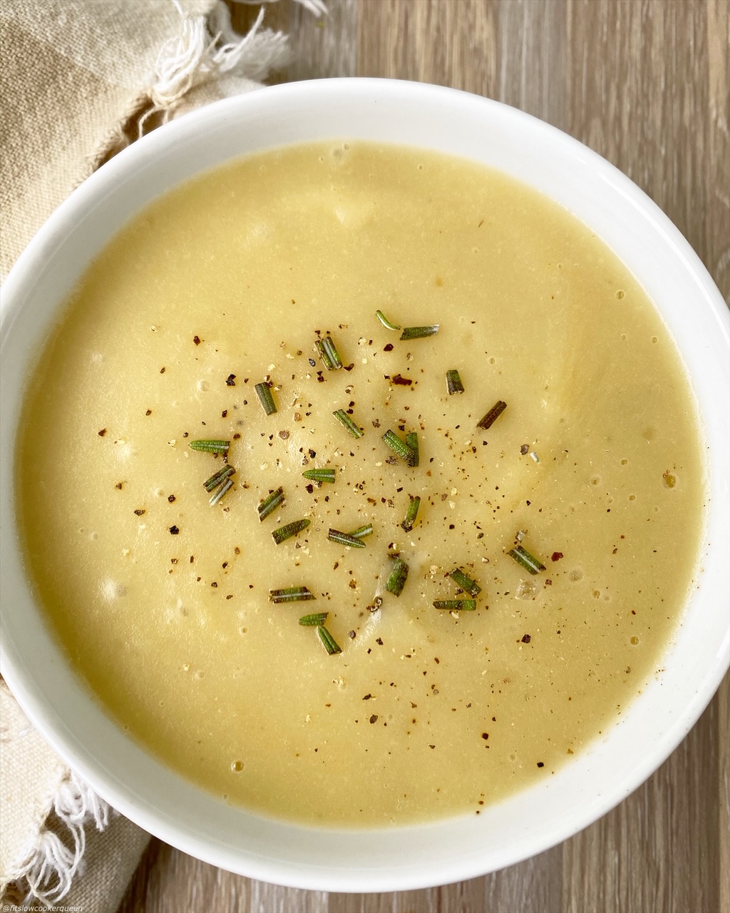 close up of potato leek soup in a white bowl