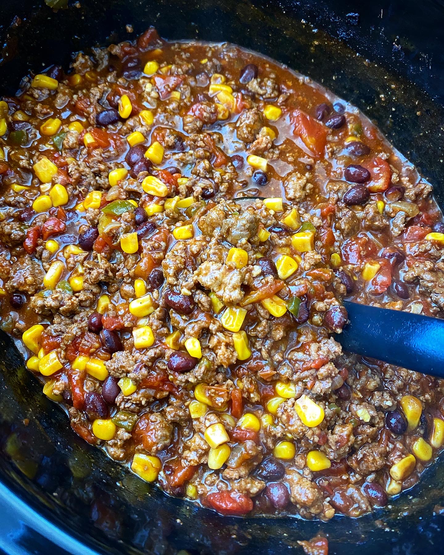 side view of cooked chorizo beef chili in the slow cooker slow cooker
