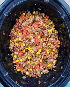 ingredients for chorizo beef chili in the slow cooker before cooking