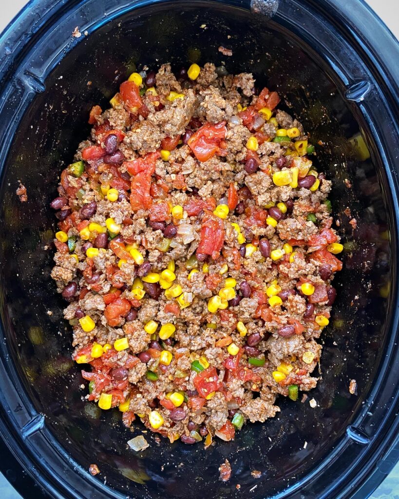 ingredients for chorizo beef chili in the slow cooker before cooking