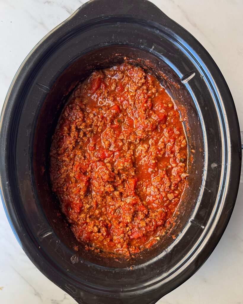 overhead shot of cooked Spaghetti Sauce in a black slow cooker