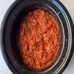 overhead shot of cooked Spaghetti Sauce in a black slow cooker