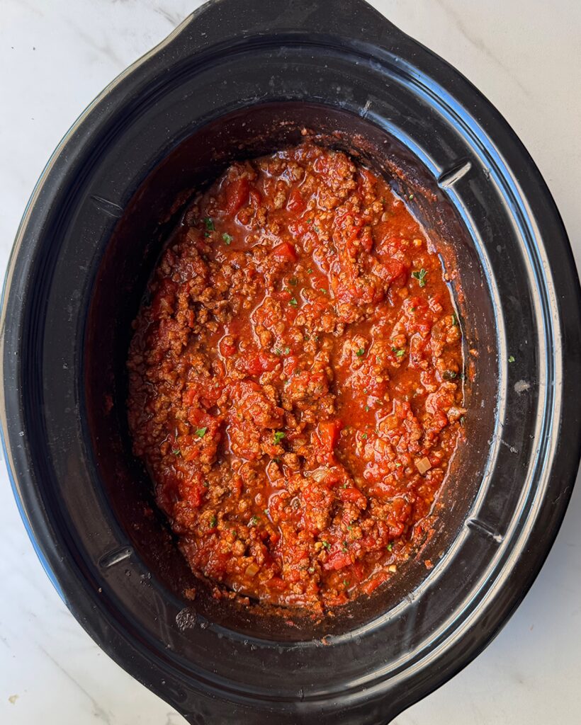overhead shot of cooked Spaghetti Sauce in a black slow cooker