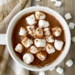 overhead shot of hot chocolate cup topped with marshmellows