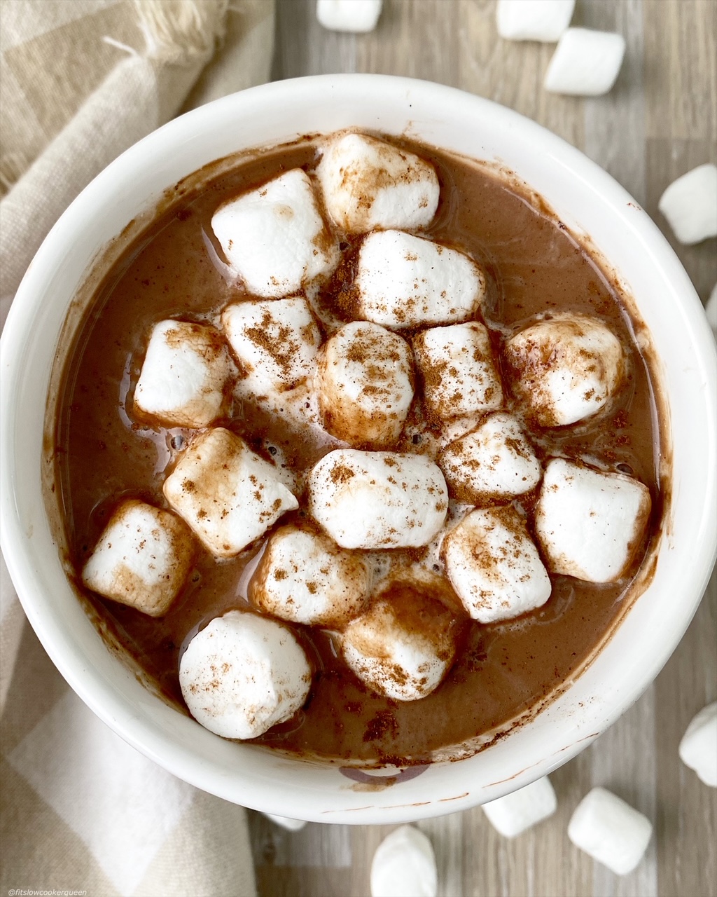 overhead shot of hot chocolate cup topped with marshmellows 