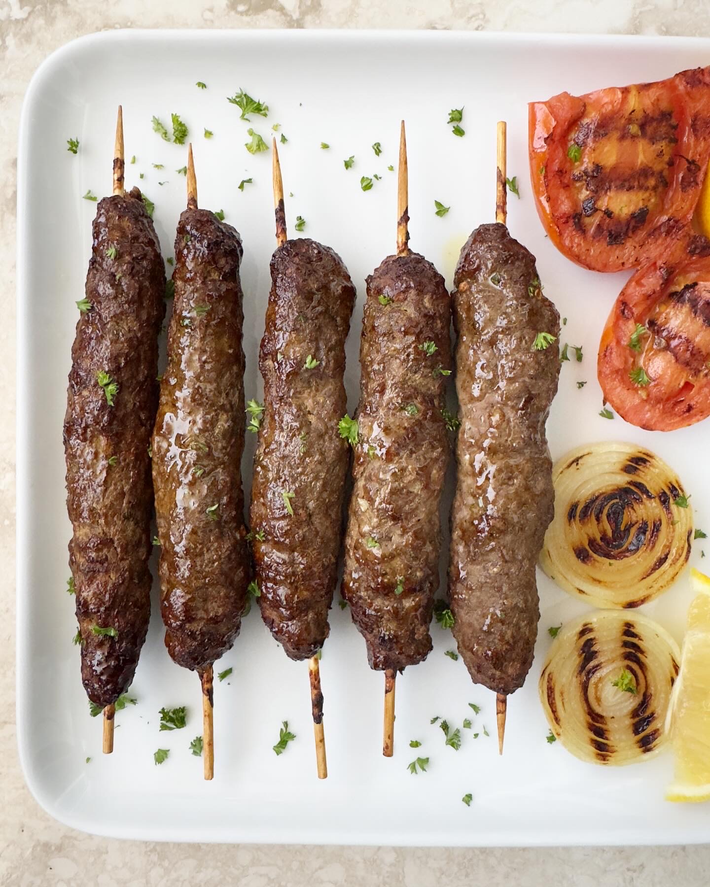 overhead shot of air fryer kofta kebab on a white plate