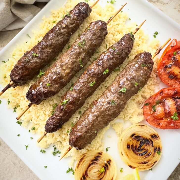 overhead shot of air fryer kofta kebab on a white plate