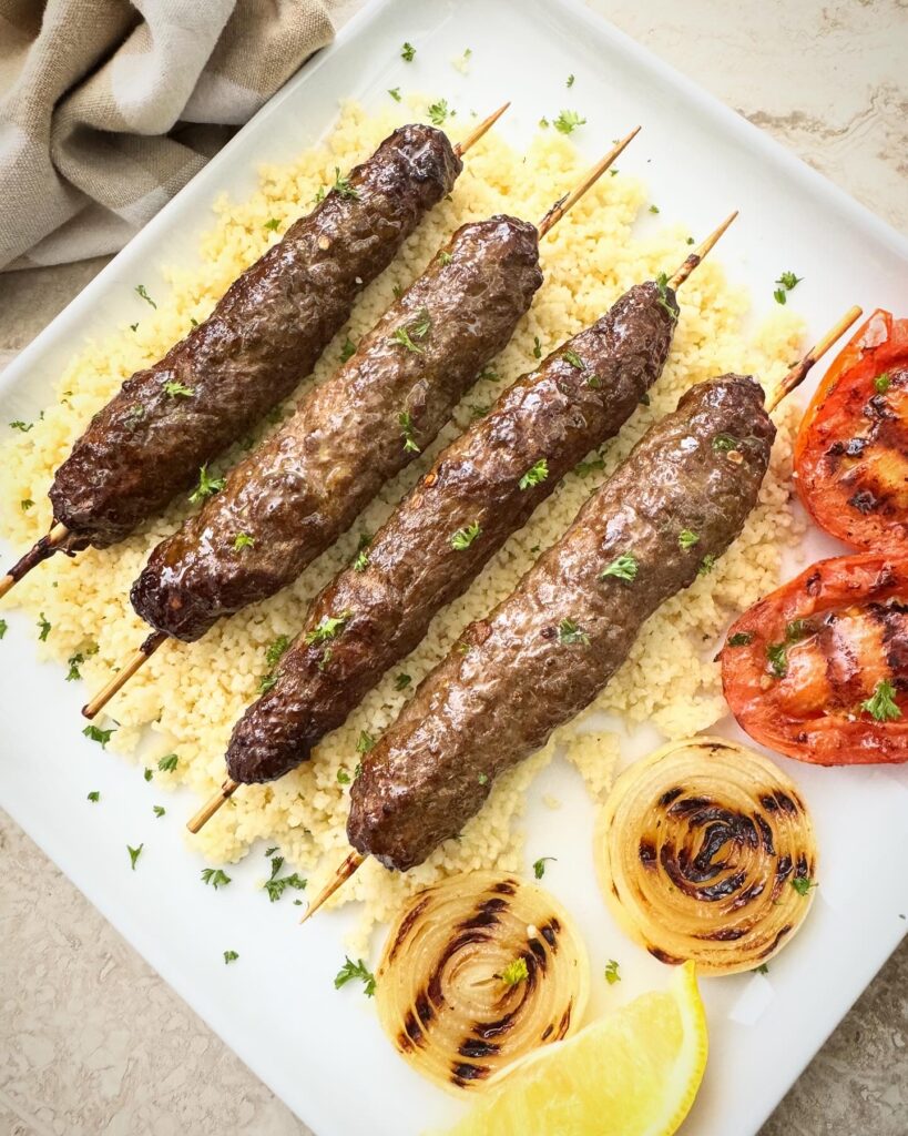 overhead shot of air fryer kofta kebab on a white plate