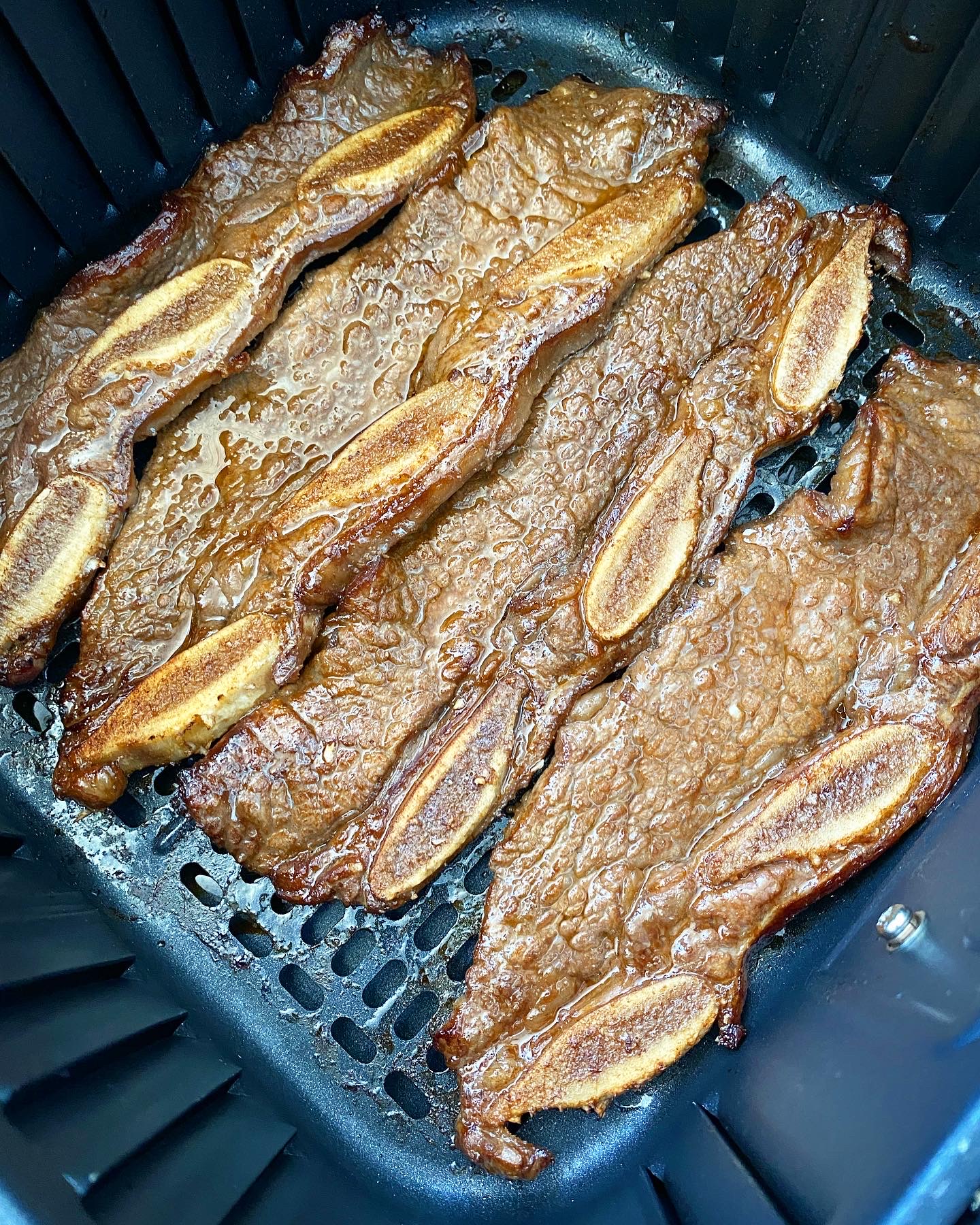 overhead shot of cooked kalbi short ribs in the air fryer