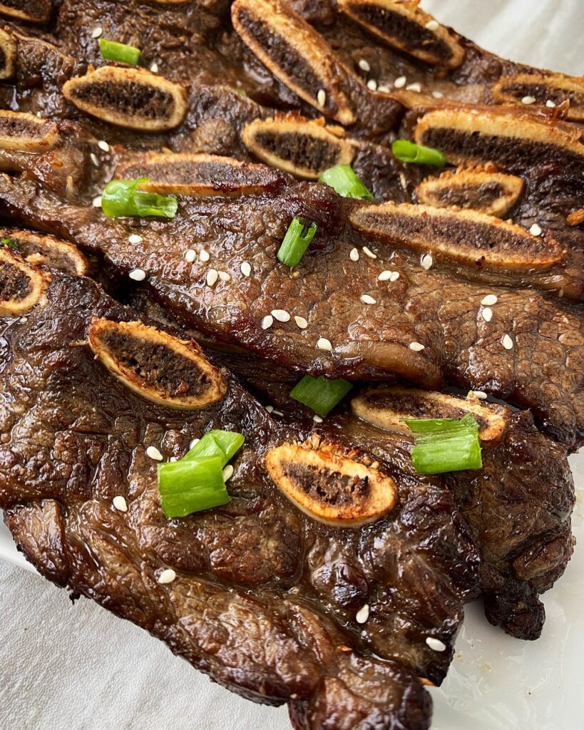 close up overhead side shot of Air Fryer Kalbi Short Ribs on a white plate