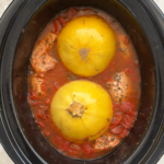 overhead shot of cooked Spaghetti Squash and Chicken in a black slow cooker