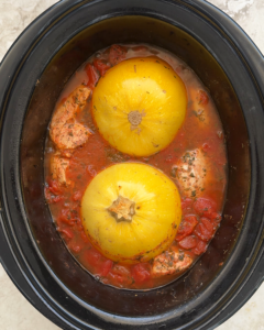 overhead shot of cooked Spaghetti Squash and Chicken in a black slow cooker