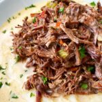 overhead shot of creole beef served over mashed potatoes
