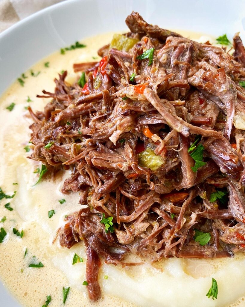 overhead shot of creole beef served over mashed potatoes