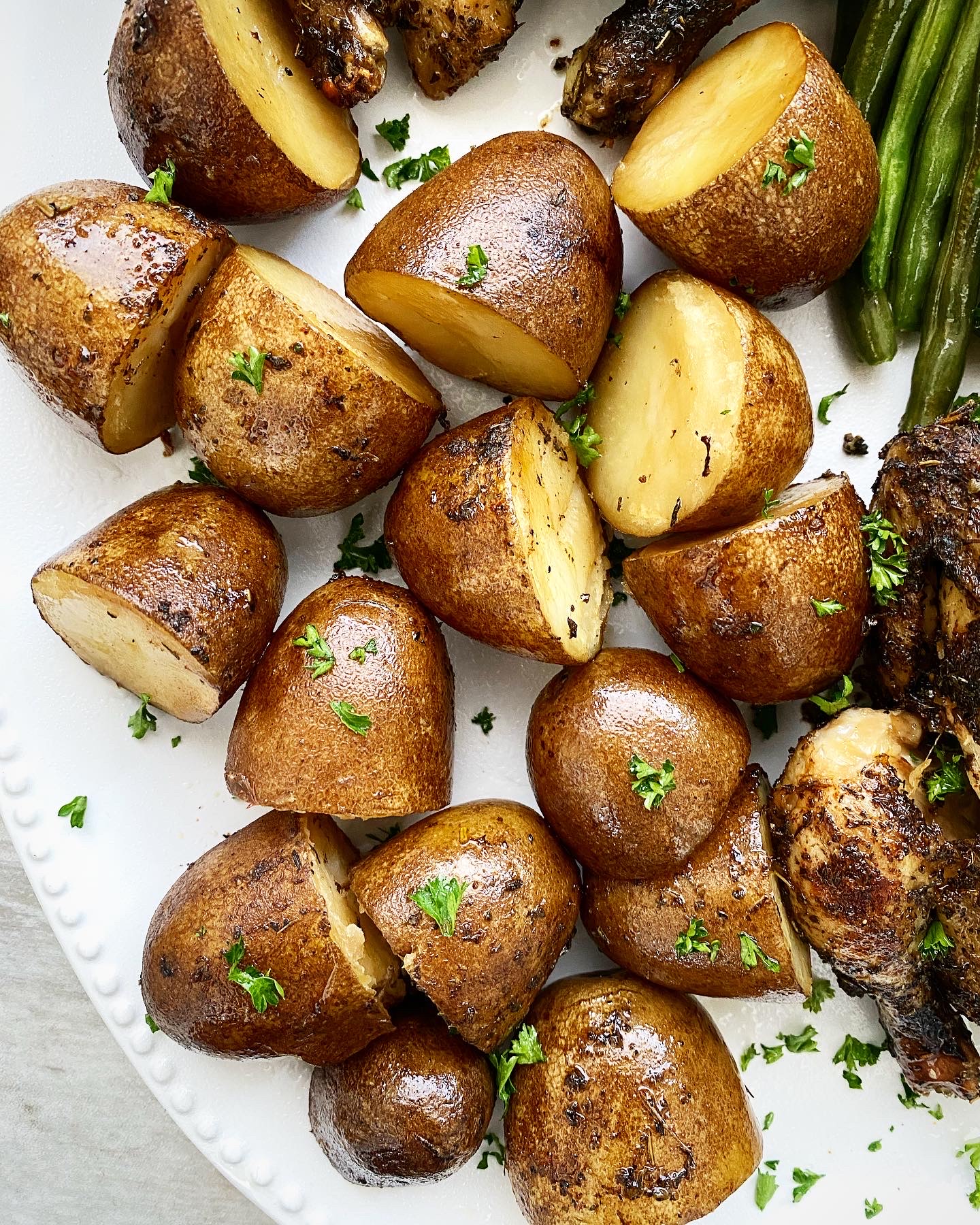 close up shot of cooked potatoes on a white platter