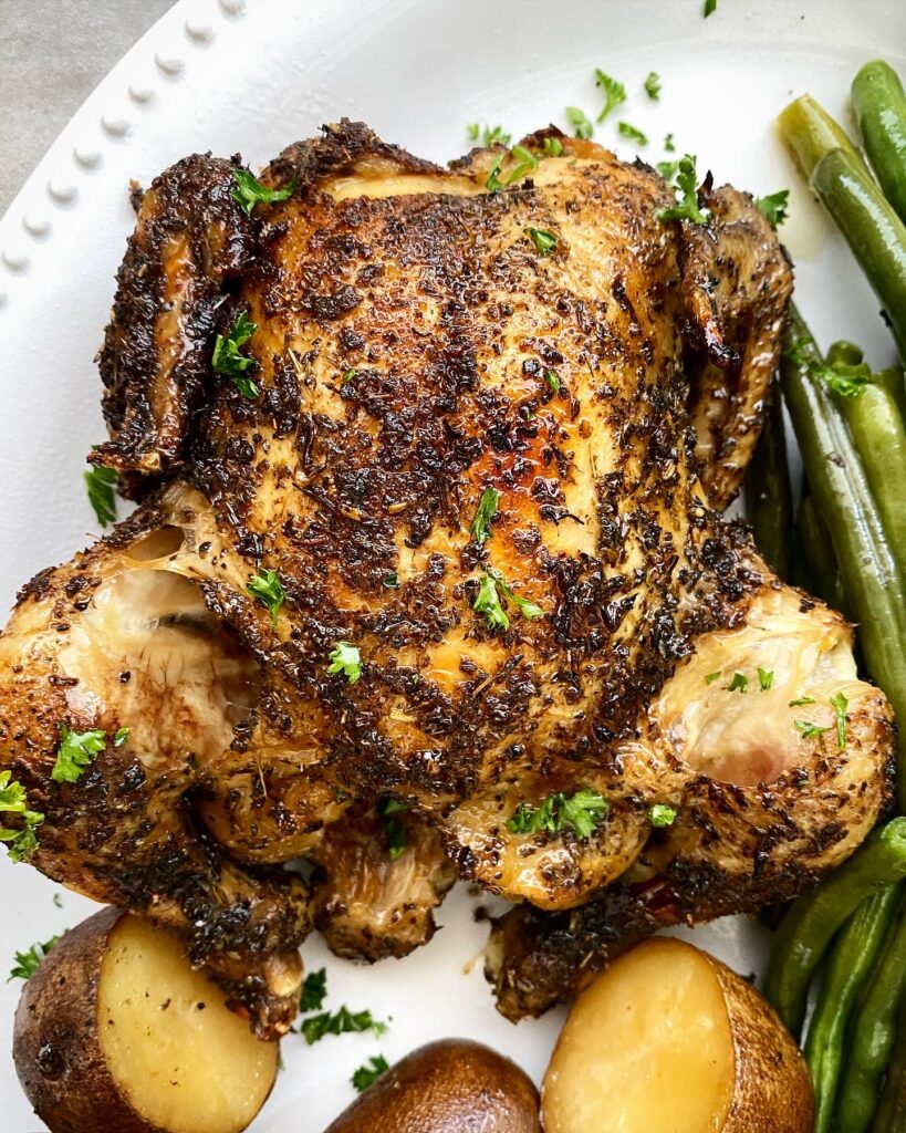 close up shot of a cooked Cornish hens, on a white platter