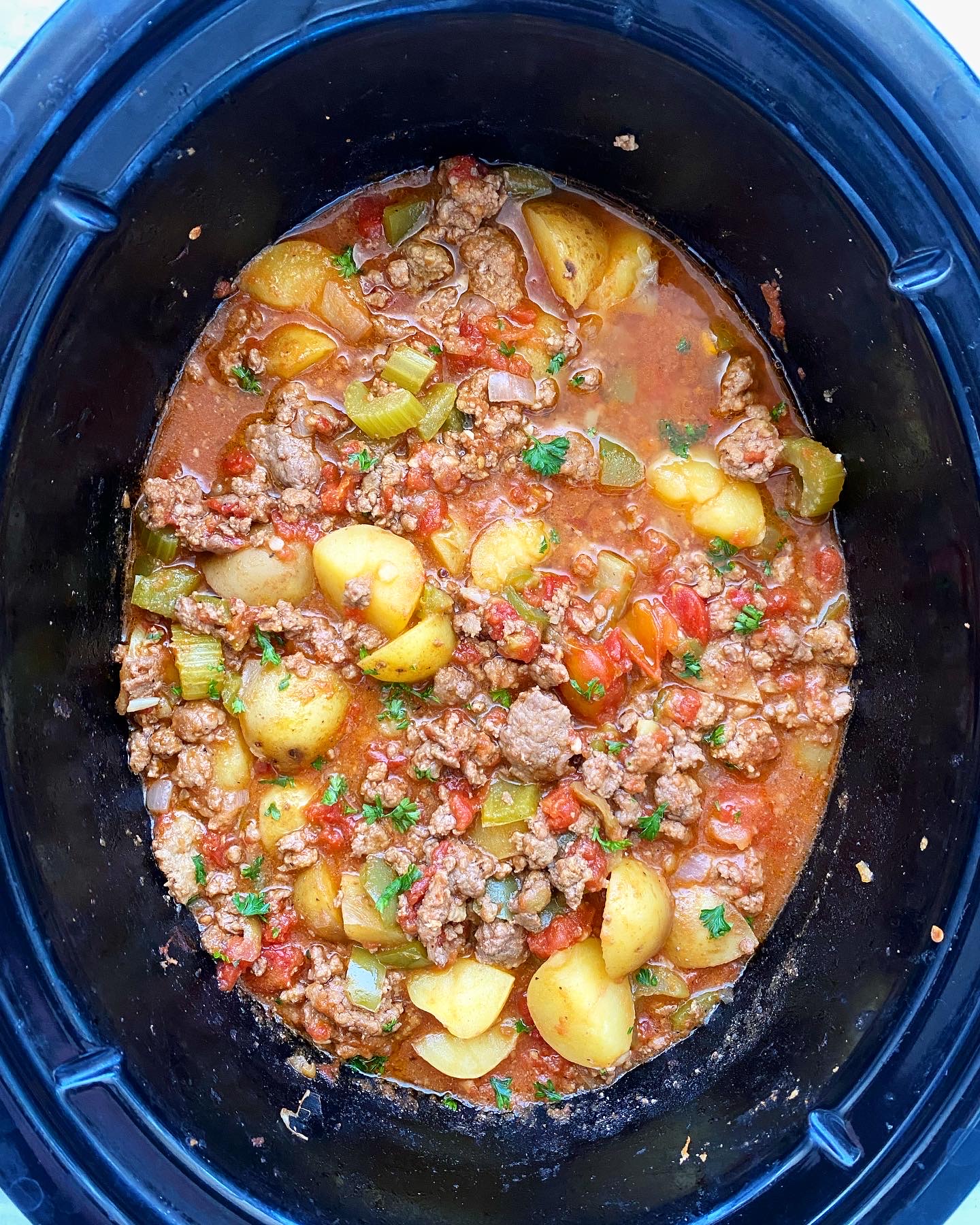 overhead shot of cooked hamburger stew in the slow cooker