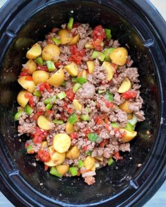overhead shot of uncooked hamburger stew in the slow cooker