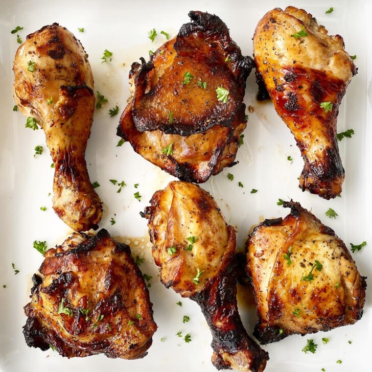 cooked marinated chicken on a white plate