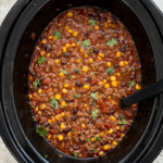 overhead shot of cooked chorizo beef chili in a black slow cooker